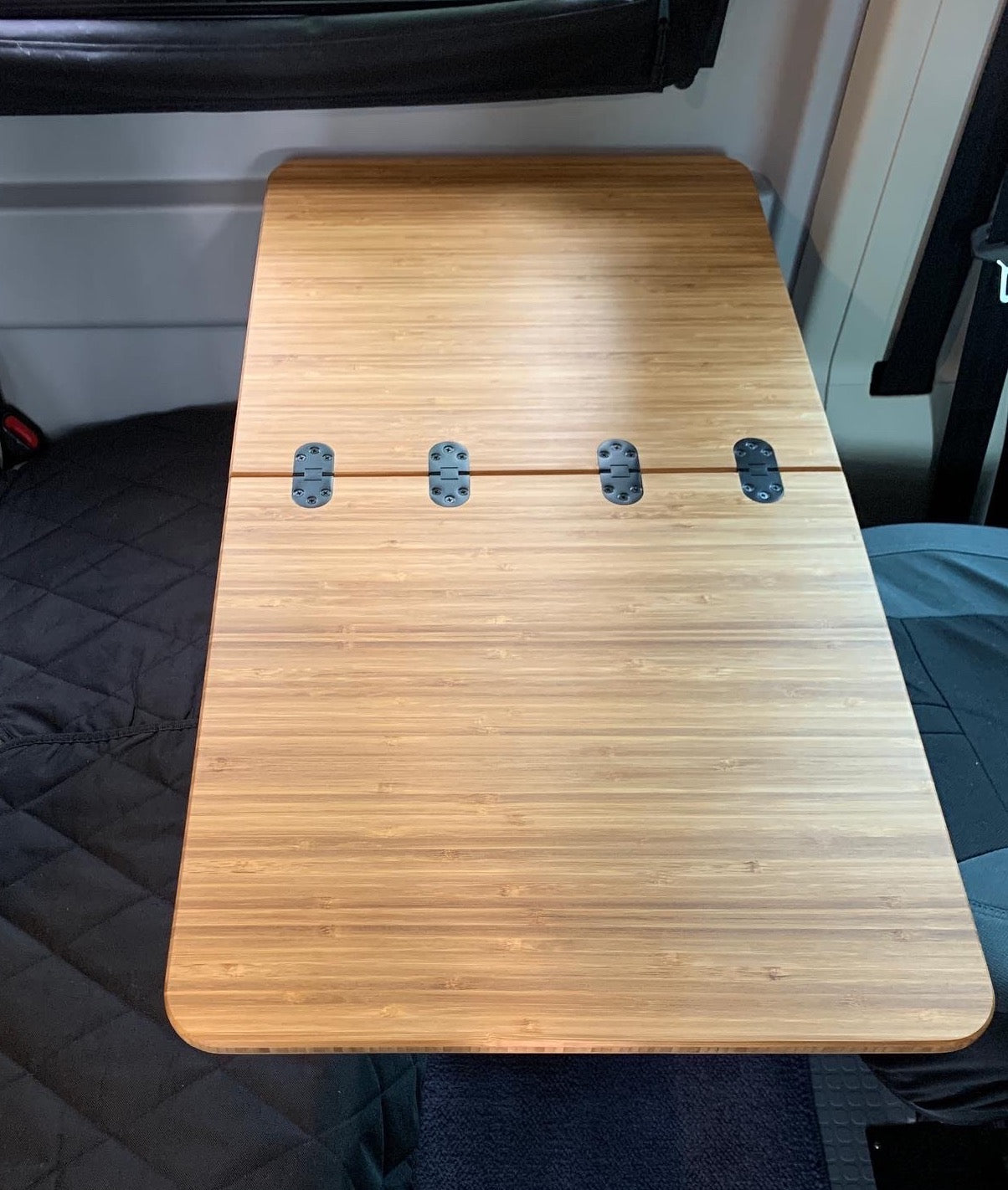 1/2" thick Folding Bamboo Table for Winnebago Solis/Revel, dimensions 18"x17.5" folded and 18"x35" open. Features a sliding support for the extension and Rubio Monocoat Natural Oil Finish. No mount included. Custom table with 1-2 week lead time.