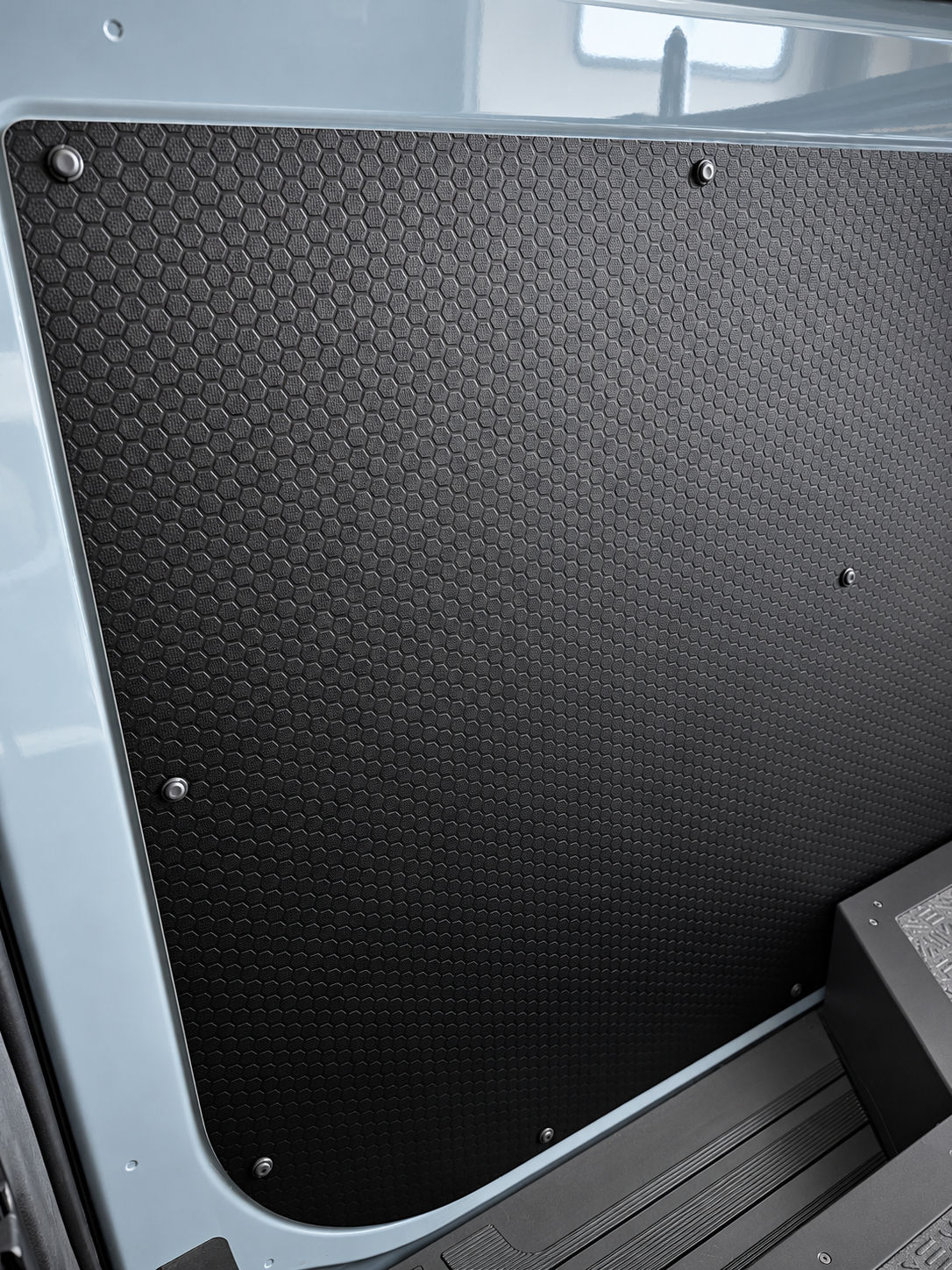 Black hex-pattern lower slider door panel with metal screws