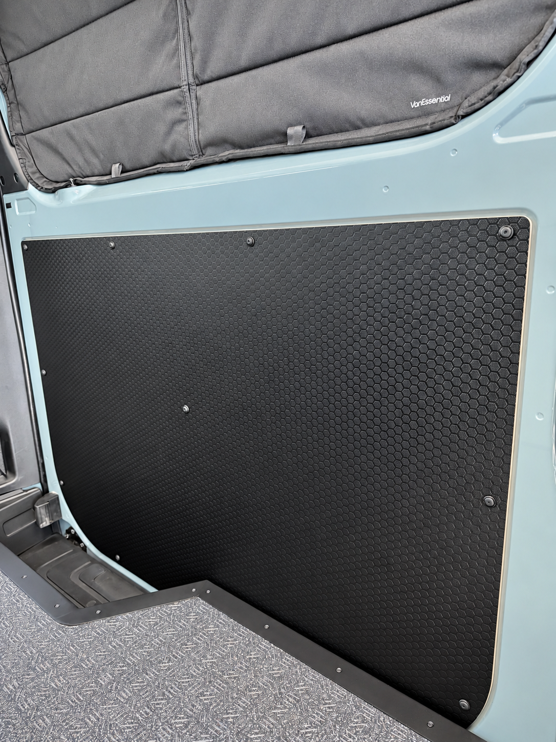 Black hex-pattern slider door panel with curved bottom edge and mounting screws