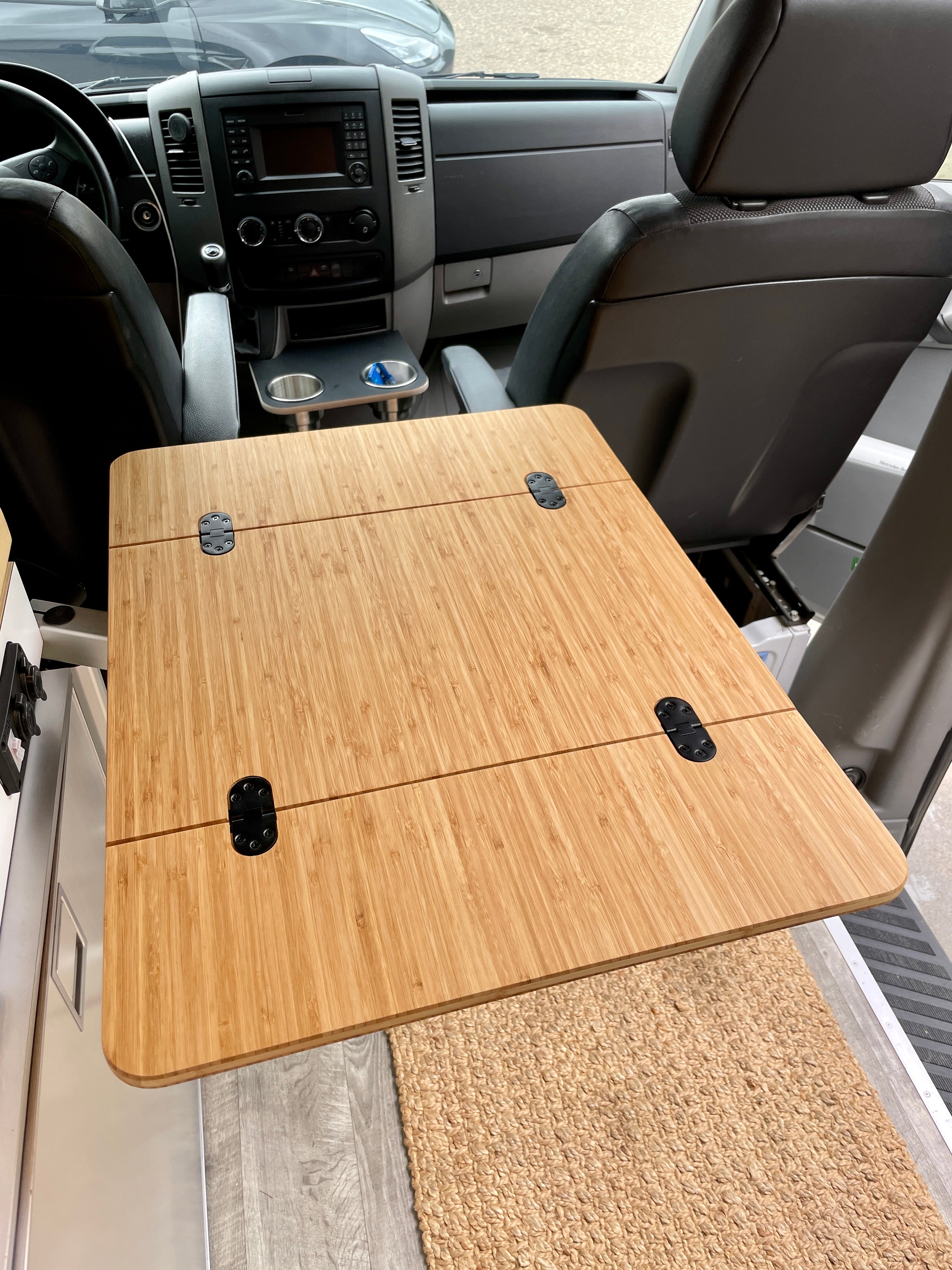 Camper Van/RV Folding Bamboo Table, 1/2" Solid Plyboo© Bamboo. Dimensions: 21 1/2"x14" folded, 21 1/2"x28" extended. Beveled edge, rounded corners, finished with Rubio Monocoat Natural Oil. Preinstalled with four mortised flush mount hinges. Handcrafted in San Diego, CA. Free UPS Ground shipping in the lower 48 USA.